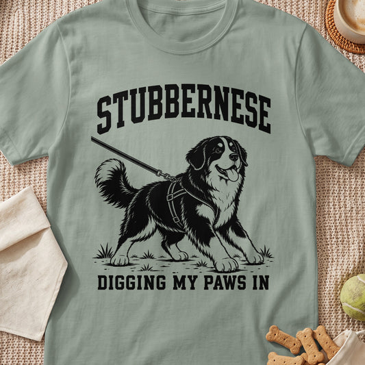 "Stubbernese Digging My Paws In" text graphic on a light green t-shirt with a dog illustration.