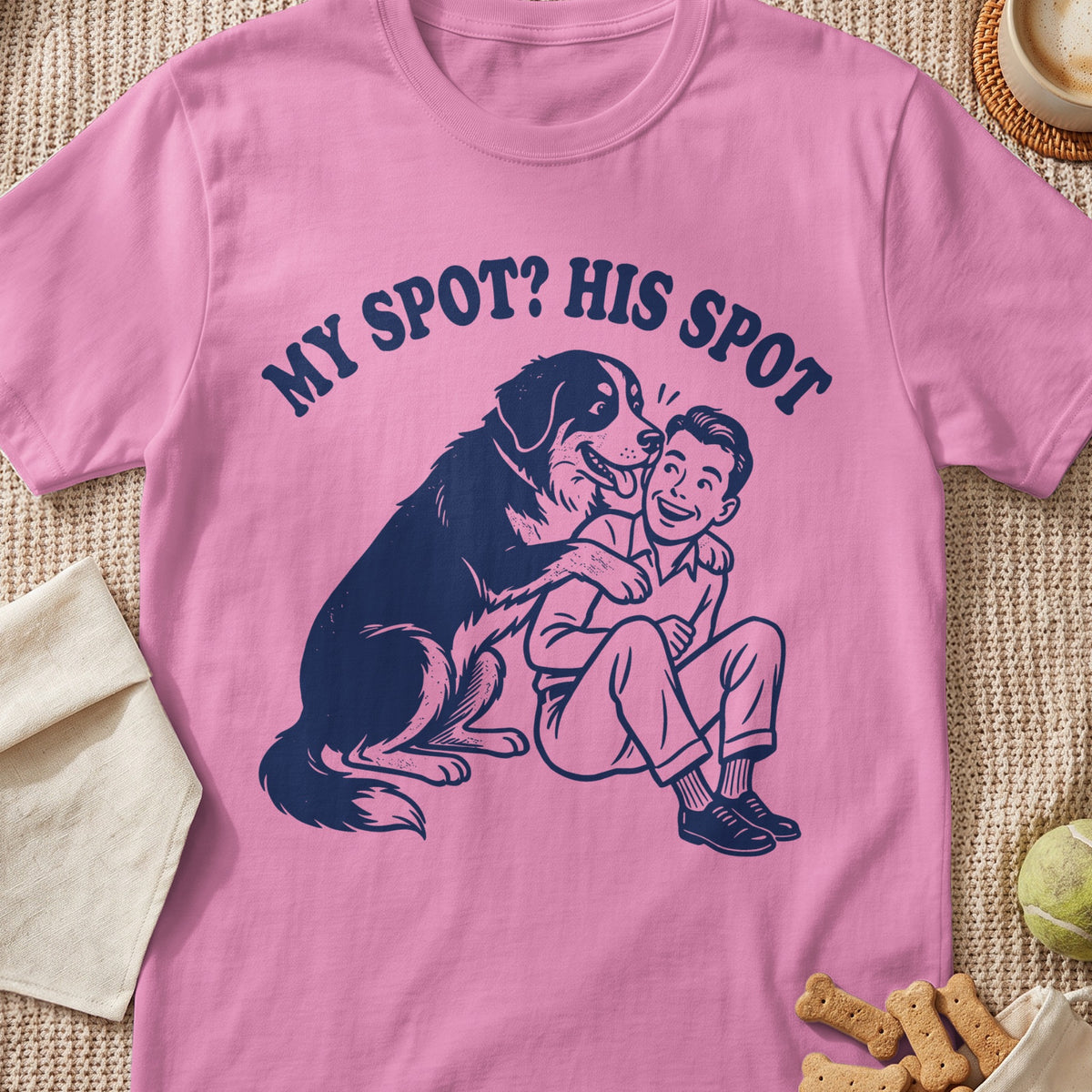 Pink t-shirt with navy graphic of dog and person with text "MY SPOT? HIS SPOT".