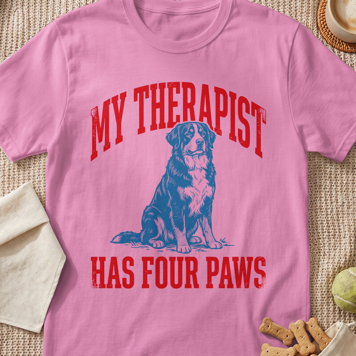 Pink t-shirt with blue dog graphic and red text "MY THERAPIST HAS FOUR PAWS".