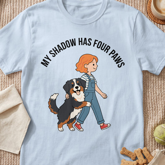 Illustration of a child and Bernese mountain dog with text "My shadow has four paws".
