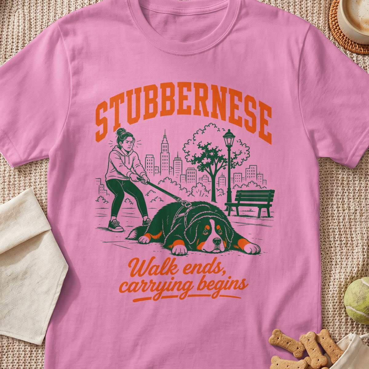Pink t-shirt with illustration of a girl struggling to walk a Bernese Mountain Dog with text.