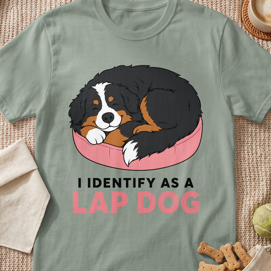 Bernese Mountain Dog sleeping in a pink bed with text "I IDENTIFY AS A LAP DOG".