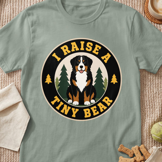 Bernese Mountain Dog on shirt with text "I RAISE A TINY BEAR"