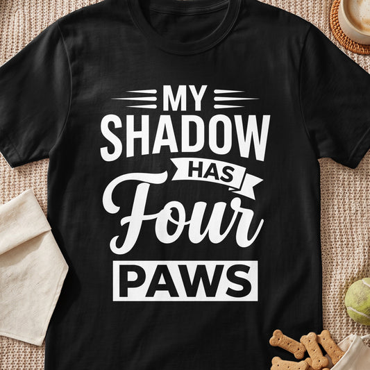 Black t-shirt with white text that reads "MY SHADOW HAS Four PAWS".
