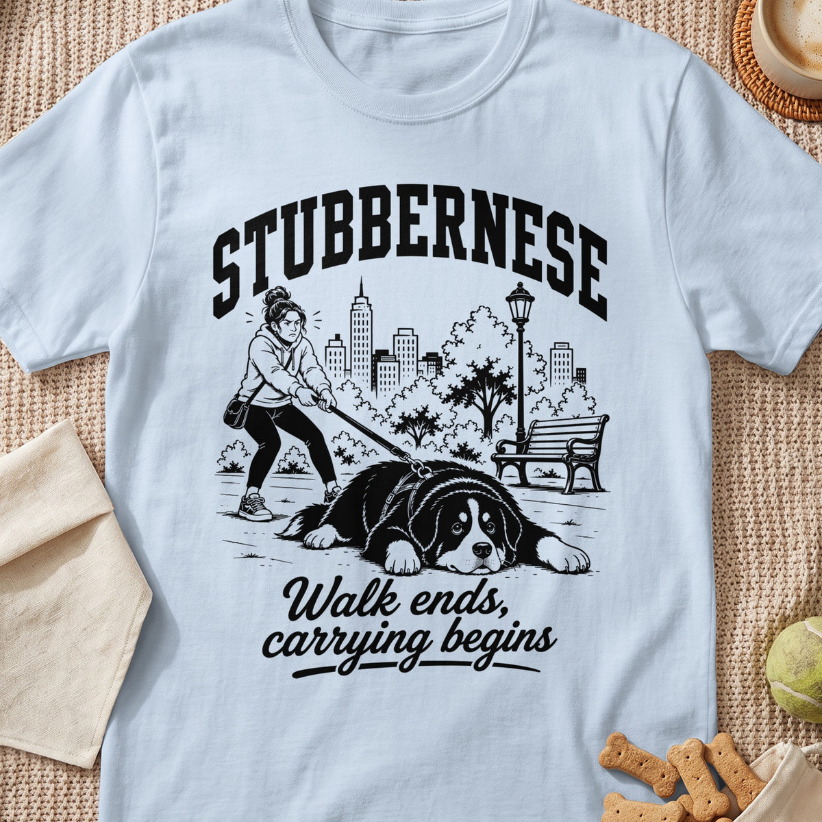 T-shirt graphic with text: Stubbernes, Walk ends, carrying begins, depicting a dog and owner.