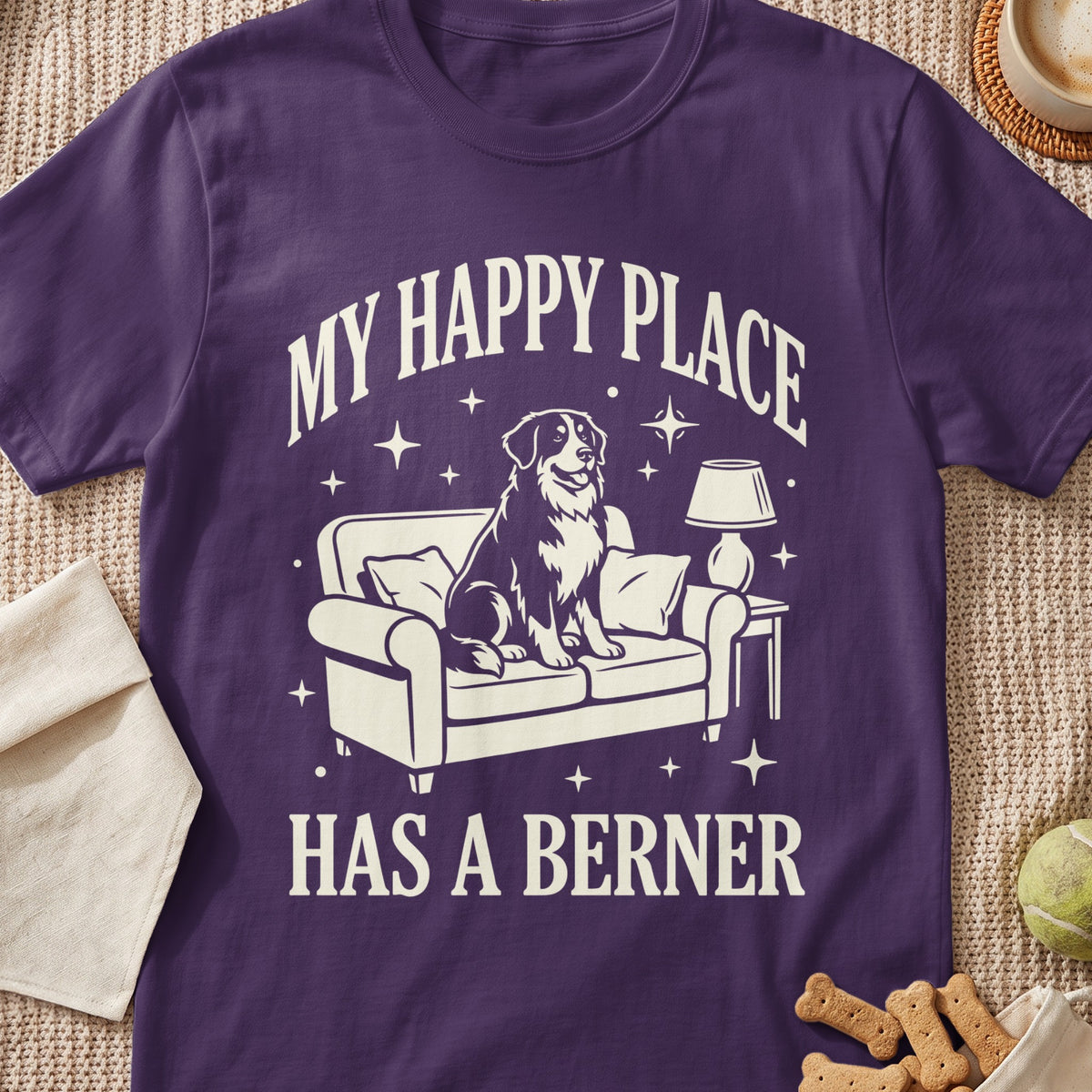 T-shirt with a graphic of a dog on a couch and text "MY HAPPY PLACE HAS A BERNER".