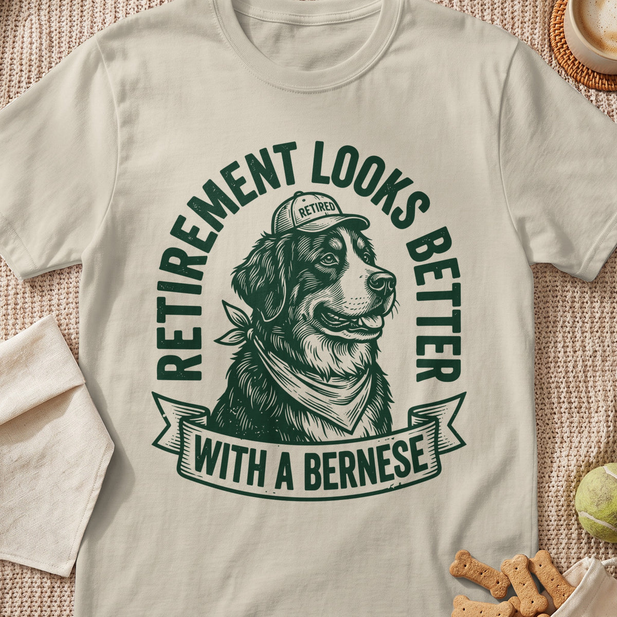 Bernese dog wearing bandana and retired cap, text "Retirement looks better with a Bernese".