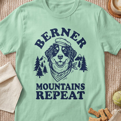 Bernese Mountain Dog wearing a cap with "BERNER MOUNTAINS REPEAT" text.