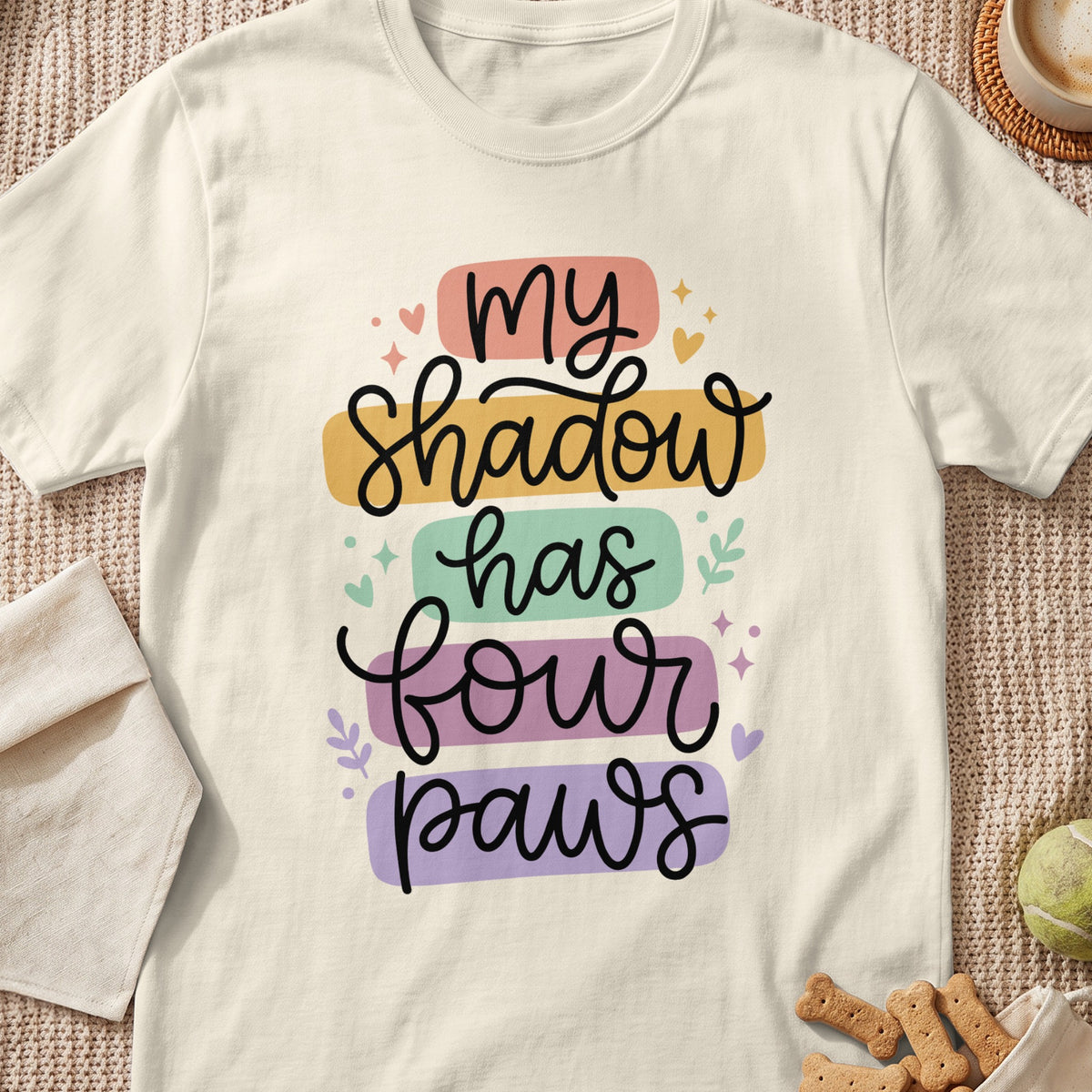 Cream t-shirt with "my shadow has four paws" in colorful stacked text.