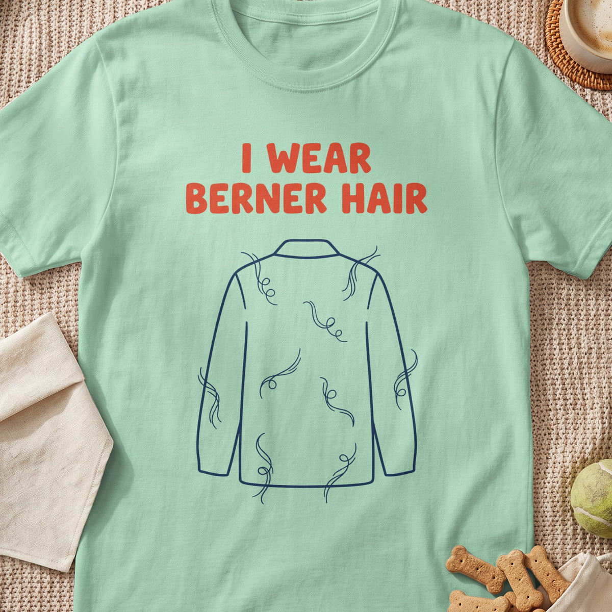 Light green t-shirt with orange text "I WEAR BERNER HAIR" and a blue outline of a dog covered in fur.