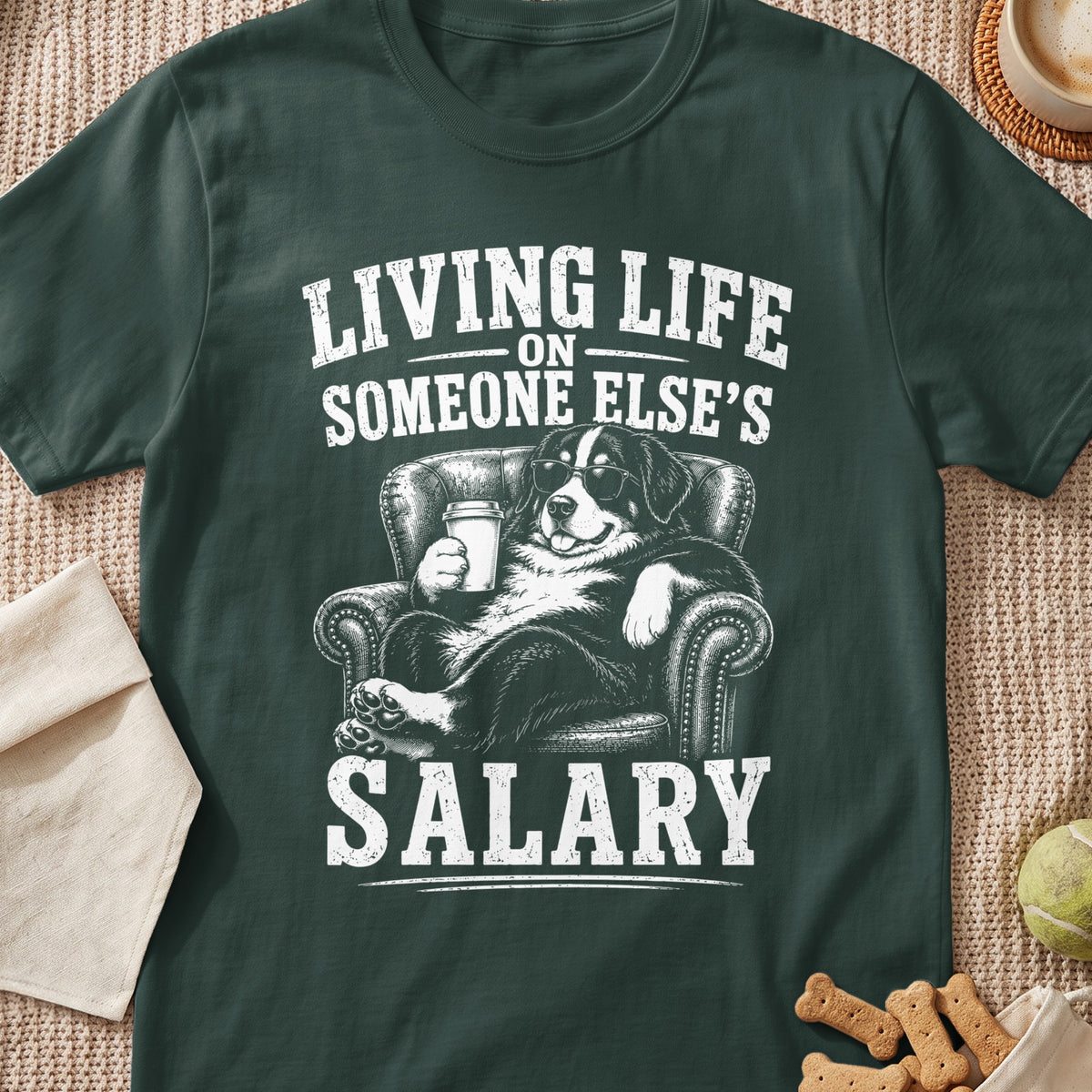 Dark green t-shirt featuring a graphic of a dog wearing sunglasses relaxing in an armchair with text.