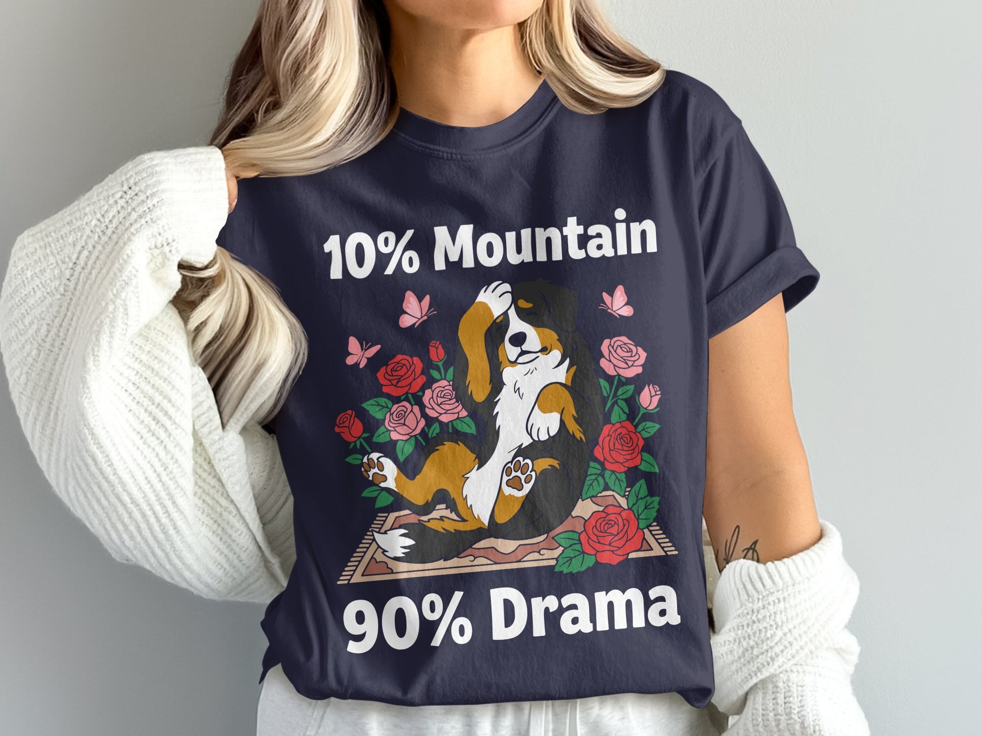 Dark blue t-shirt with a drawing of a Bernese Mountain Dog surrounded by roses and butterflies, text reads "10% Mountain 90% Drama"