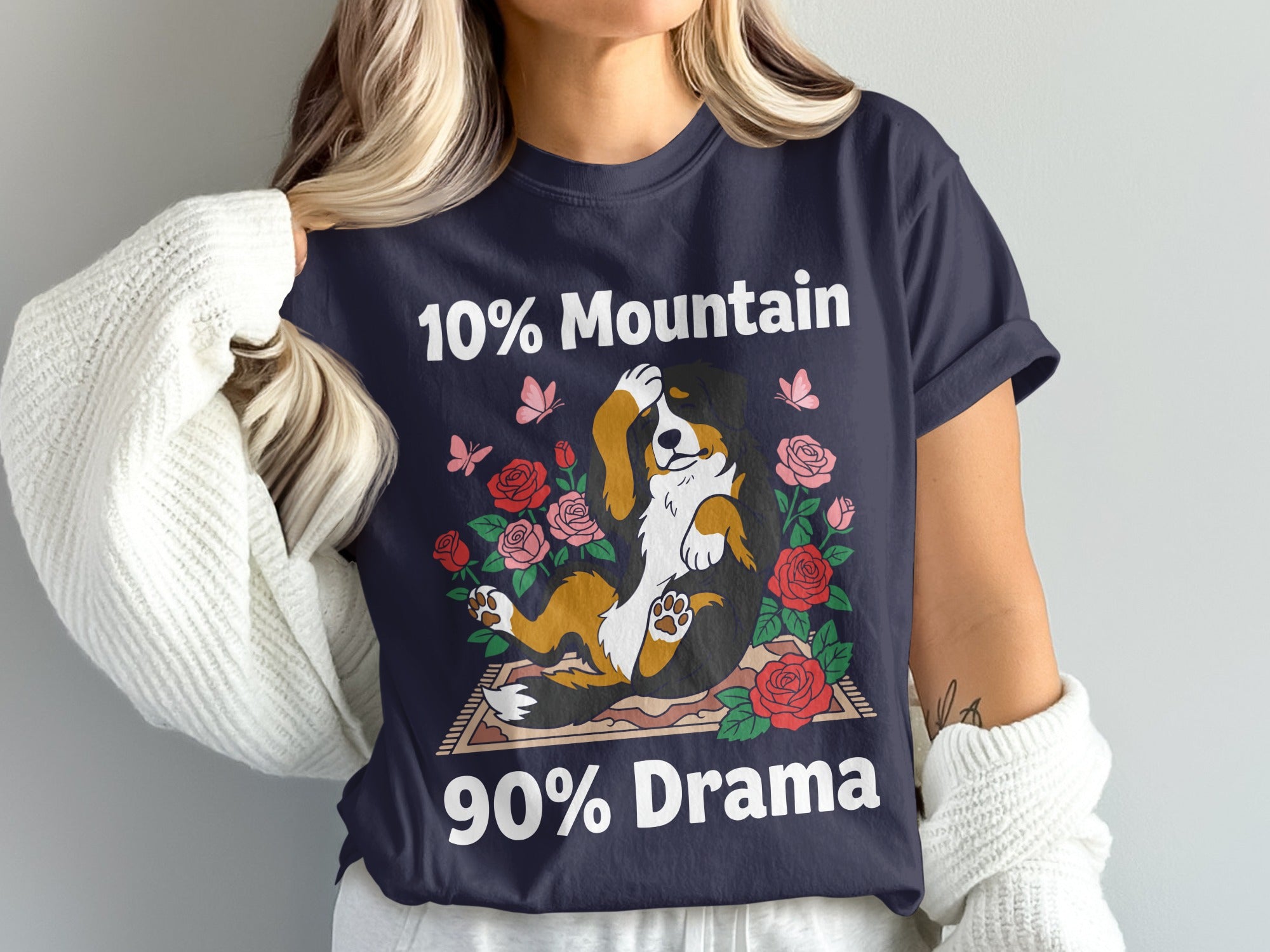 Dark blue t-shirt with a drawing of a Bernese Mountain Dog surrounded by roses and butterflies, text reads "10% Mountain 90% Drama"