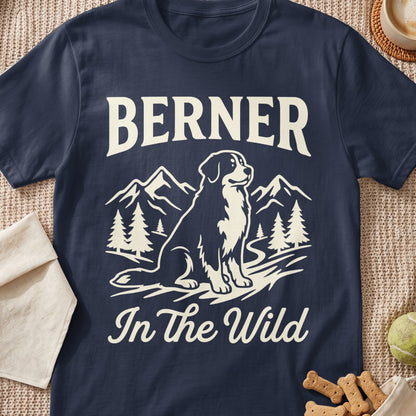 Bernese Mountain Dog sitting in a mountain landscape with text "BERNER In The Wild".