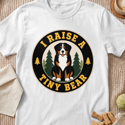 Bernese Mountain Dog graphic with text "I RAISE A TINY BEAR" on white t-shirt.