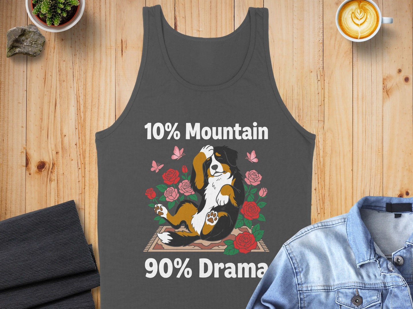 Bernese Mountain Dog relaxing in roses with text "10% Mountain 90% Drama".