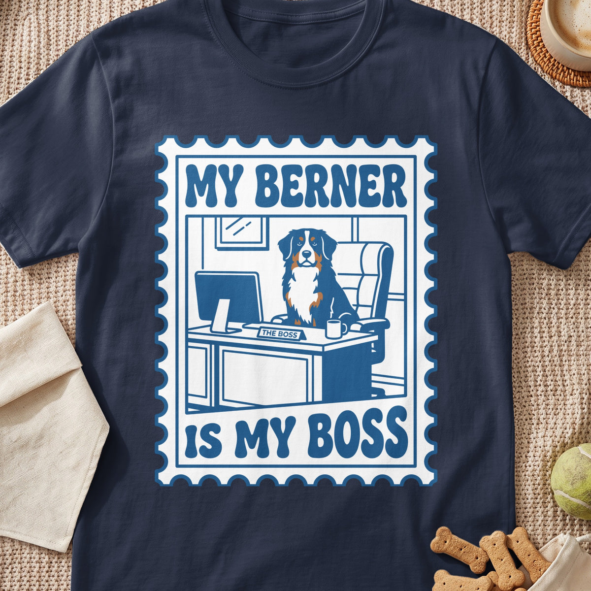 Navy blue t-shirt featuring a graphic of a Bernese Mountain Dog at an office desk with text reading My Berner Is My Boss.