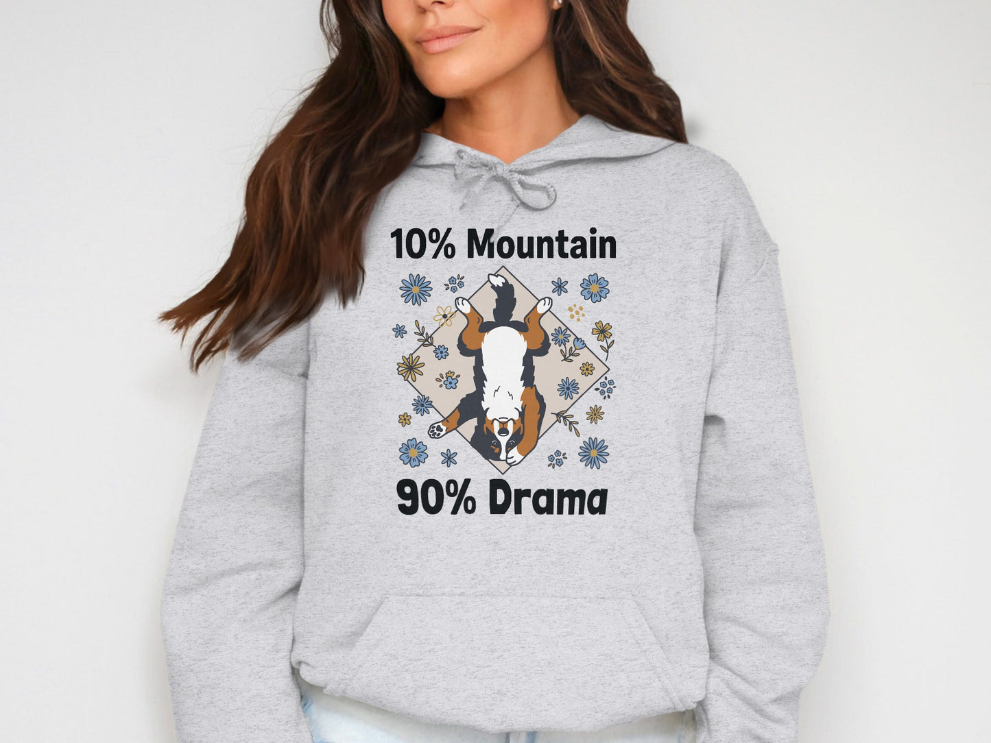 Grey hoodie with a dog and flowers graphic that reads "10% Mountain 90% Drama".