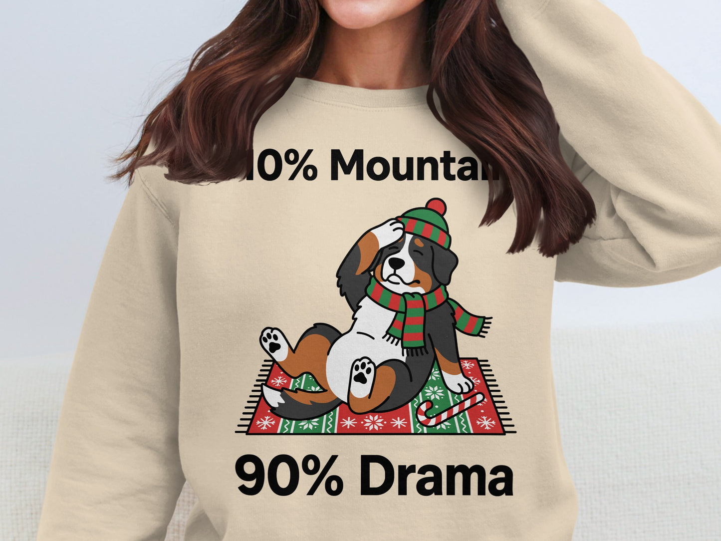 Bernese Mountain Dog wearing a festive scarf and hat with text "10% Mountain 90% Drama".