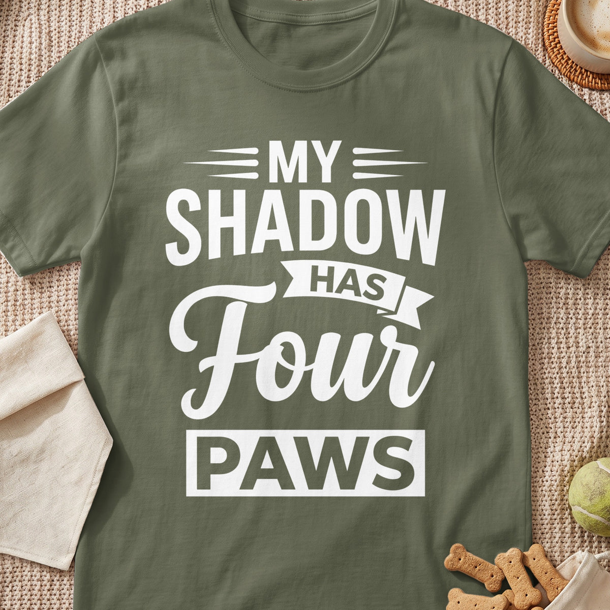 Olive green t-shirt with white text: "MY SHADOW HAS FOUR PAWS".