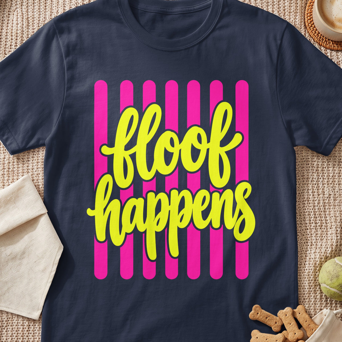 Navy t-shirt with yellow text "floof happens" on pink stripes.