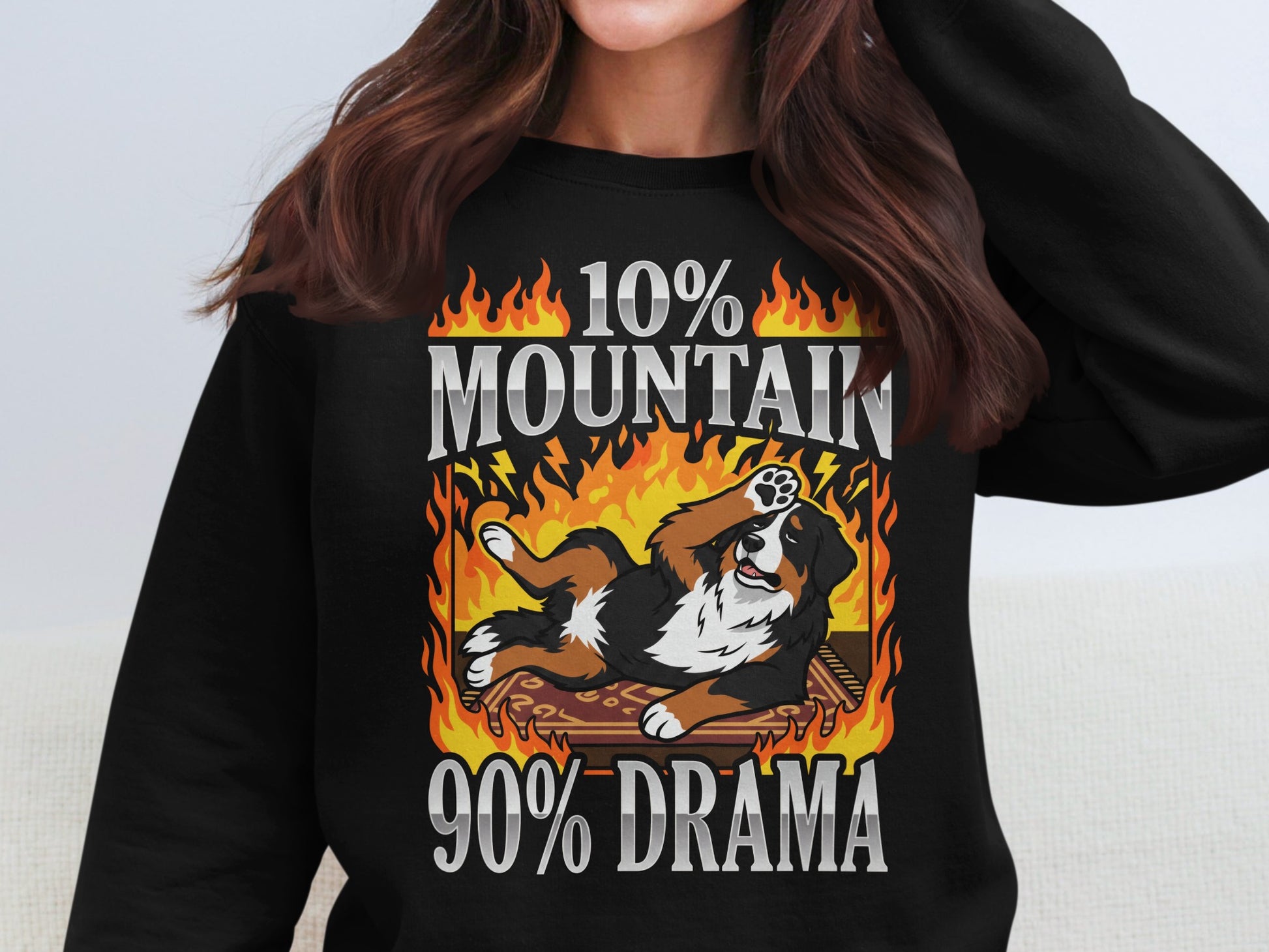 Bernese Mountain Dog on a rug surrounded by flames with text "10% MOUNTAIN 90% DRAMA"