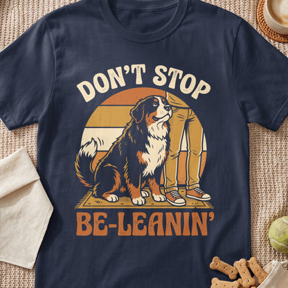 Bernese Mountain Dog sitting next to person, text "DON'T STOP BE-LEANIN'".