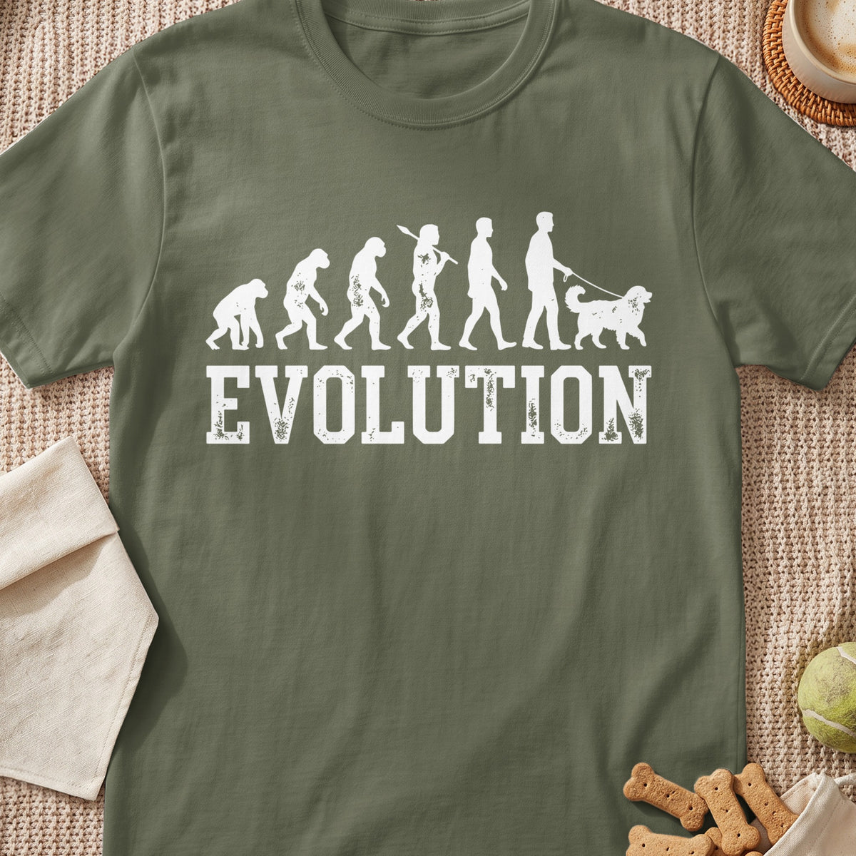 Olive t-shirt with white "Evolution" text and human evolutionary stages, ending with a person walking a dog.