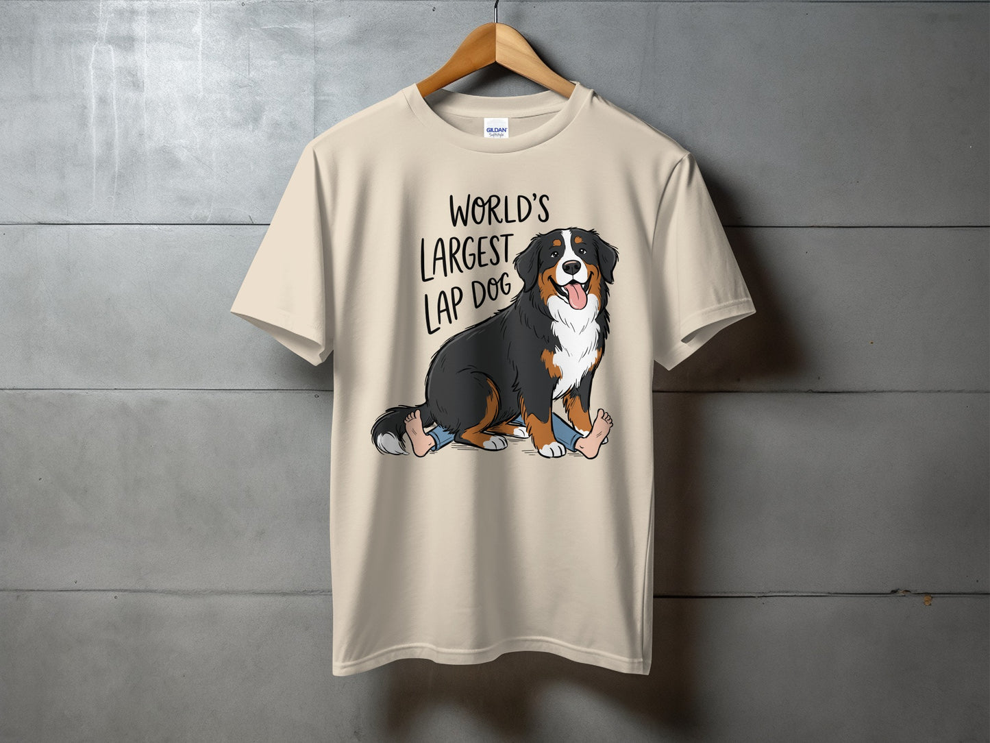 T-shirt with cartoon Bernese Mountain Dog sitting on legs, text: World's Largest Lap Dog.