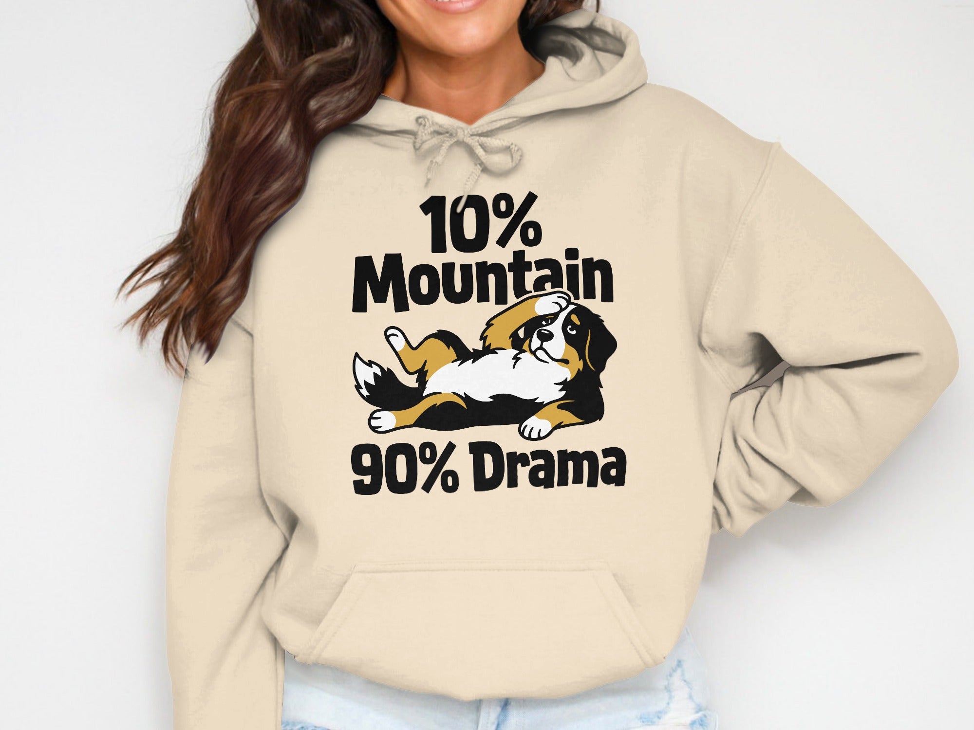 Bernese Mountain Dog graphic on tan hoodie reads "10% Mountain 90% Drama."
