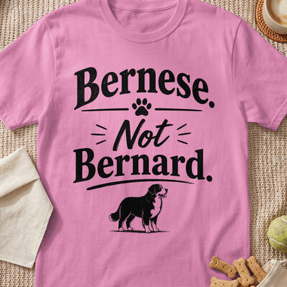Pink t-shirt with text "Bernese. Not Bernard." and a dog illustration.