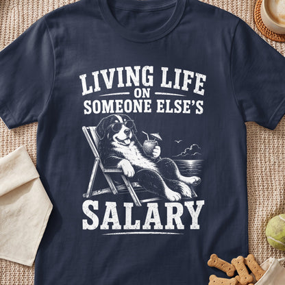 Bernese mountain dog in sunglasses relaxes on beach chair with drink, text says "Living Life On Someone Else's Salary."
