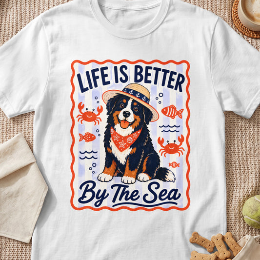 Bernese Mountain Dog wearing straw hat and bandana, "Life Is Better By The Sea" text.