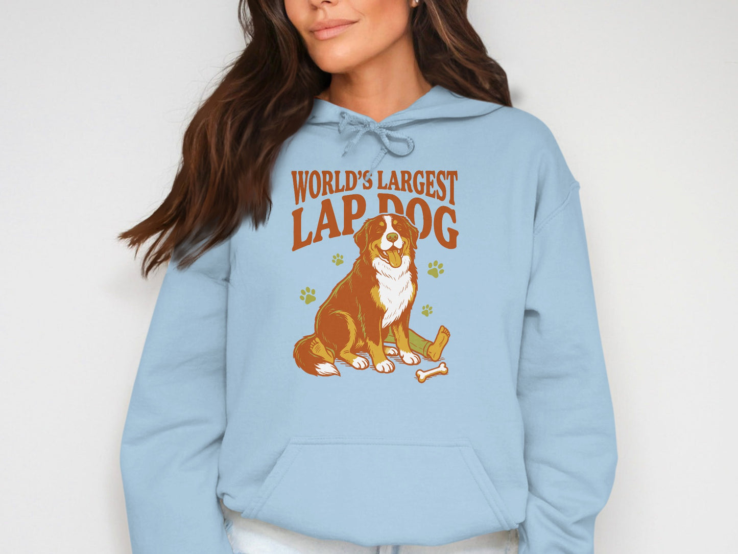 Bernese Mountain Dog illustration with text "World's Largest Lap Dog" on a blue hoodie.