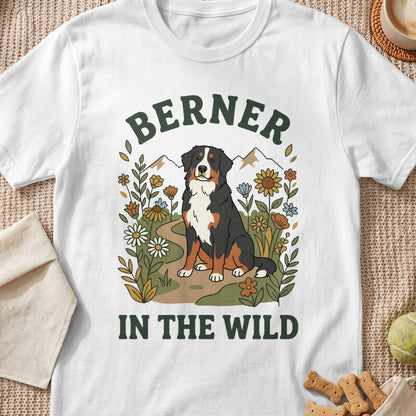 White t-shirt with a Bernese Mountain Dog sitting amongst flowers and text "BERNER IN THE WILD".