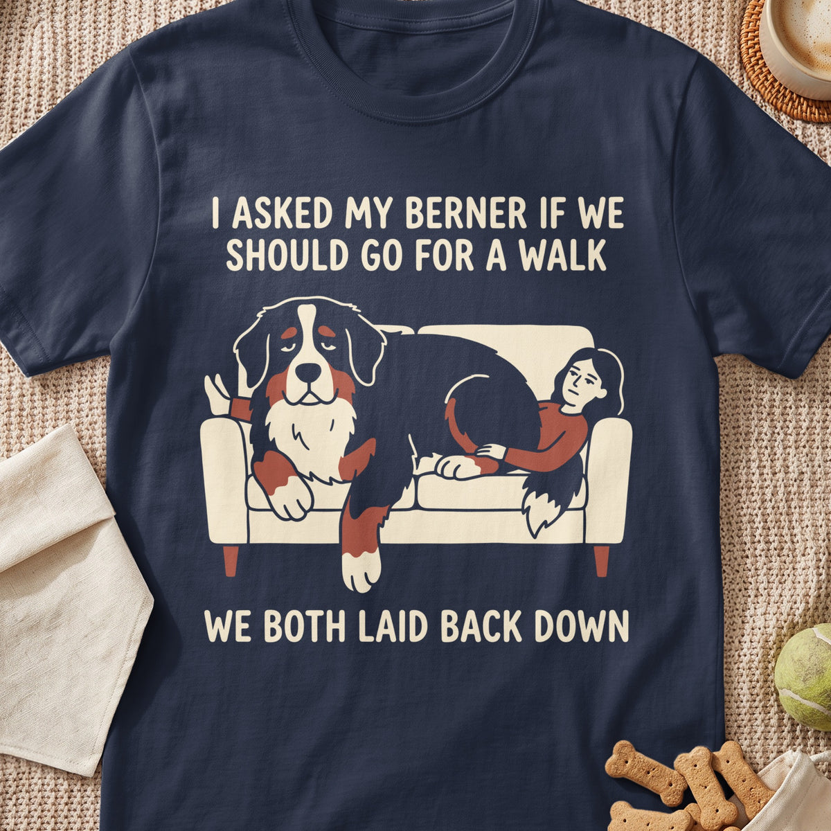 Dark blue t-shirt with graphic of a Bernese Mountain Dog and person lounging on a couch.