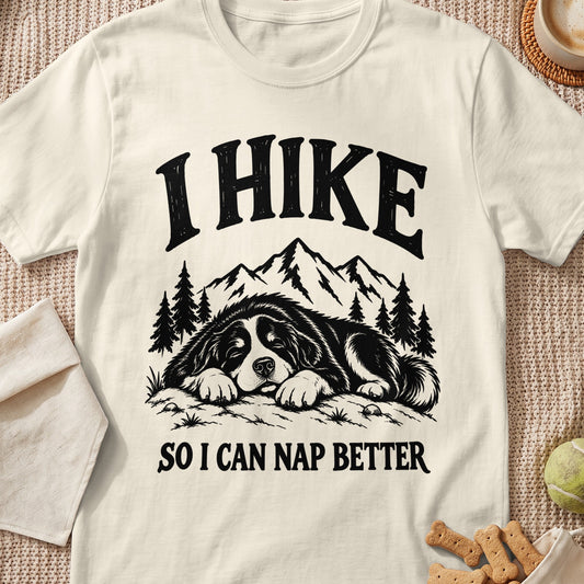 Cream t-shirt with black text "I HIKE SO I CAN NAP BETTER" and a sleeping dog graphic.