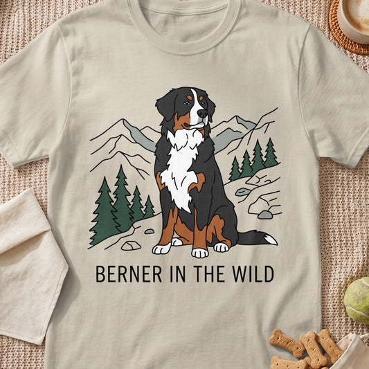 Bernese Mountain Dog sits in a stylized mountain landscape with text "BERNER IN THE WILD."