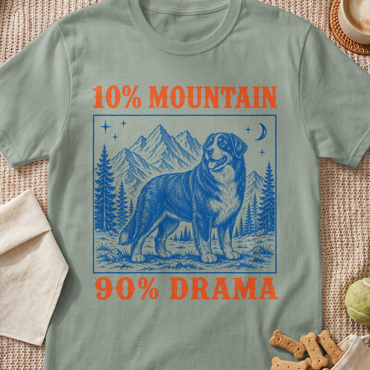 Green t-shirt graphic with "10% MOUNTAIN 90% DRAMA" and a dog in mountains.