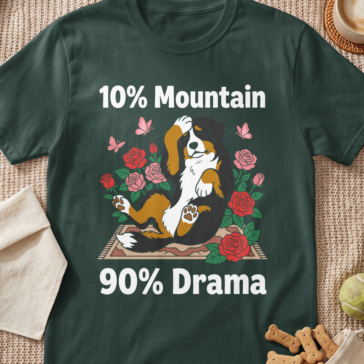 Bernese Mountain Dog lying among roses with text "10% Mountain 90% Drama".