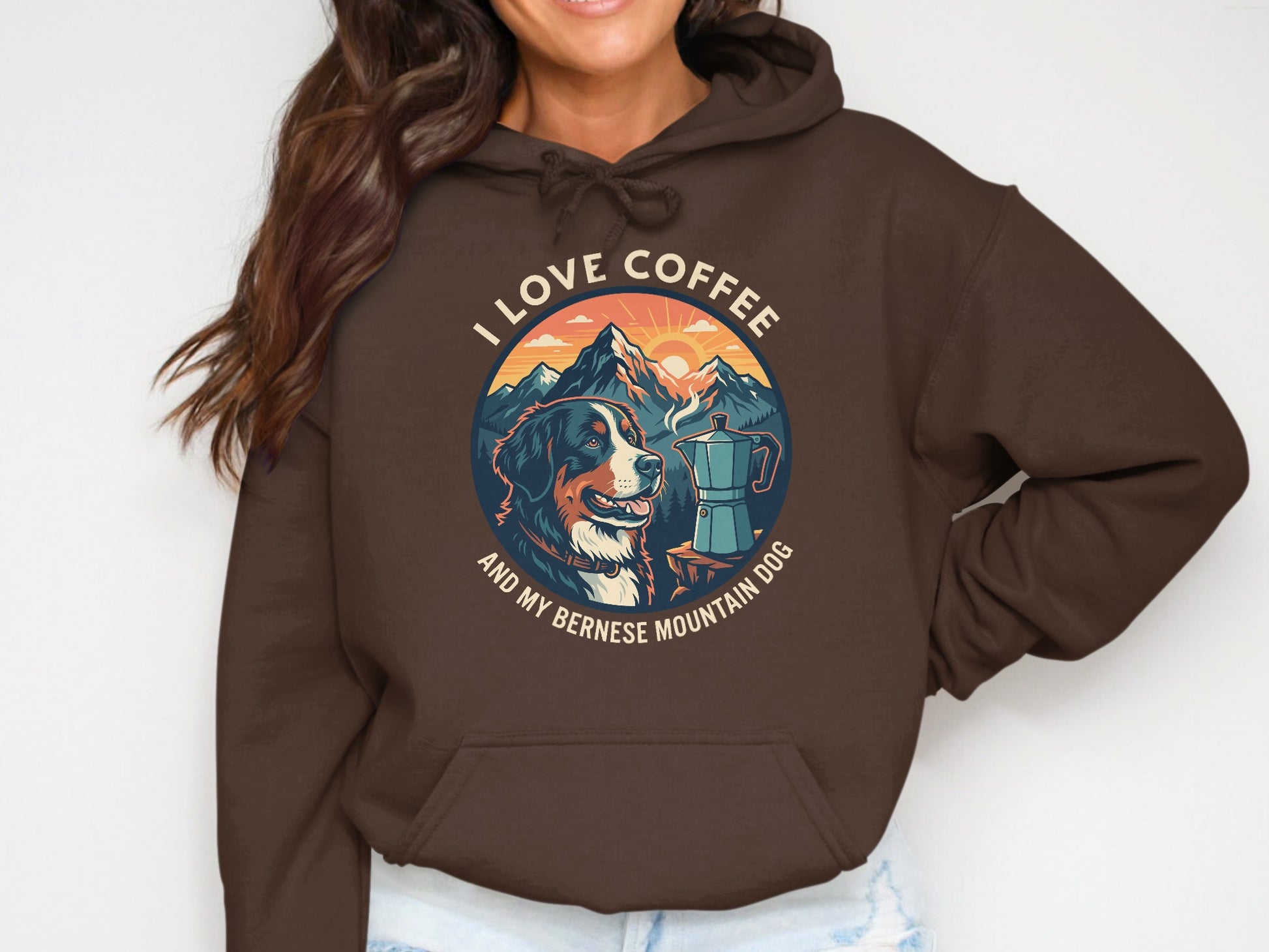 Brown hoodie with a circular graphic of a Bernese Mountain Dog, coffee pot, and mountains.