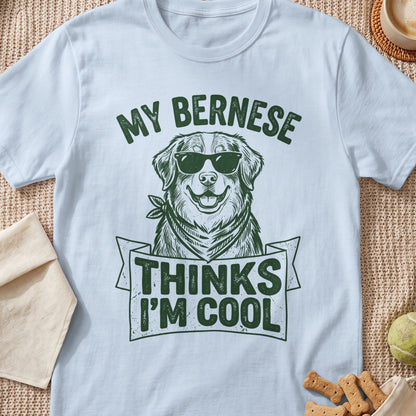 Light blue t-shirt with green text and a drawing of a Bernese Mountain Dog wearing sunglasses.