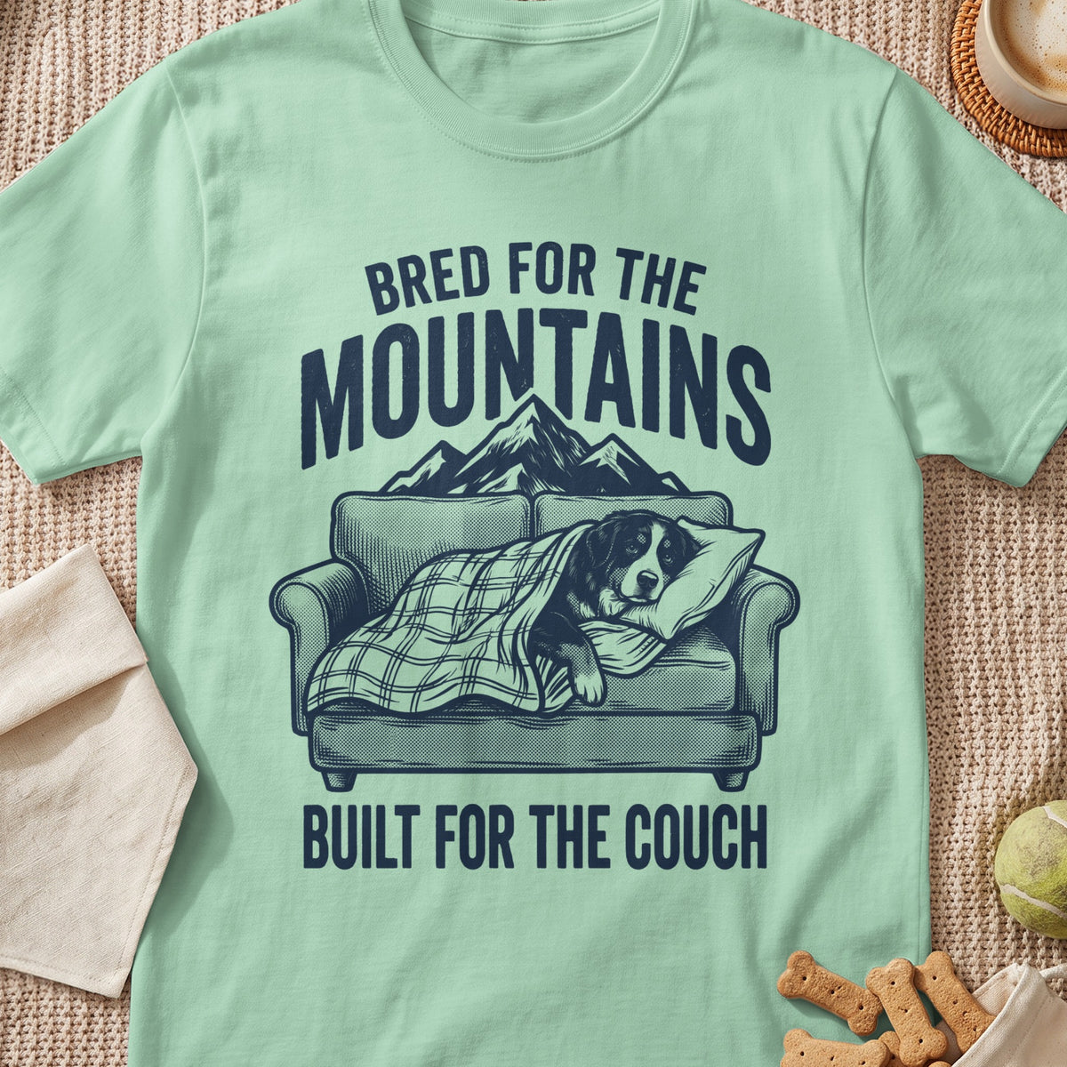 T-shirt with dog on couch graphic and text "Bred for the Mountains Built for the Couch."