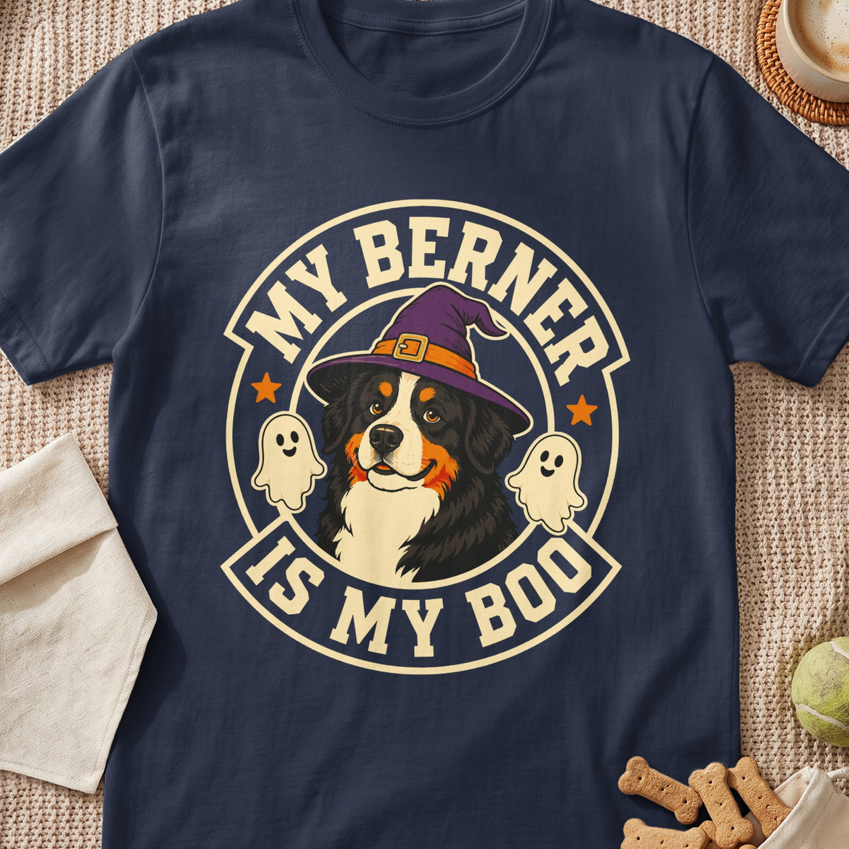 A dark blue t-shirt featuring a graphic of a Bernese Mountain Dog wearing a witch hat, flanked by ghosts, with the text MY BERNER IS MY BOO.