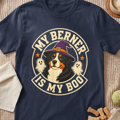 A dark blue t-shirt featuring a graphic of a Bernese Mountain Dog wearing a witch hat, flanked by ghosts, with the text MY BERNER IS MY BOO.