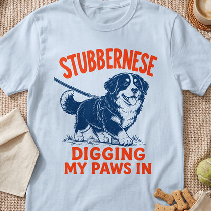 White t-shirt with orange text "STUBBERNESE DIGGING MY PAWS IN" and a Bernese Mountain Dog illustration.