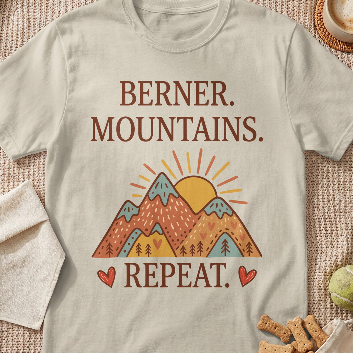 Berner. Mountains. Repeat. graphic on a cream t-shirt with a mountain sunset.
