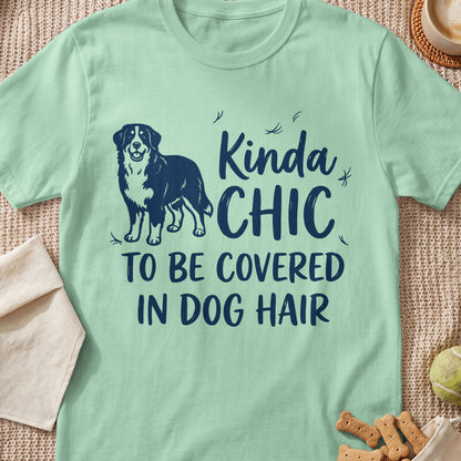 Light green t-shirt with navy blue text and dog graphic that reads "Kinda CHIC TO BE COVERED IN DOG HAIR".
