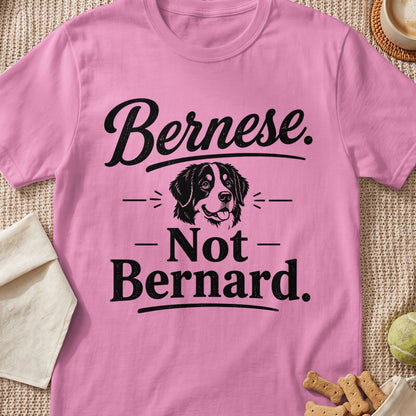 Pink t-shirt with black text "Bernese. - Not - Bernard." and a dog illustration.