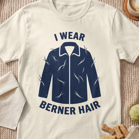 Cream t-shirt with navy graphic of a jacket covered in fur strands and text "I WEAR BERNER HAIR".